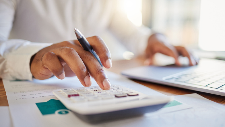 Person looking at their finances and using calculator
