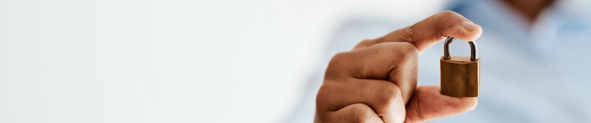 Man holding a lock, symbolizing security, protection, and safe banking practices.