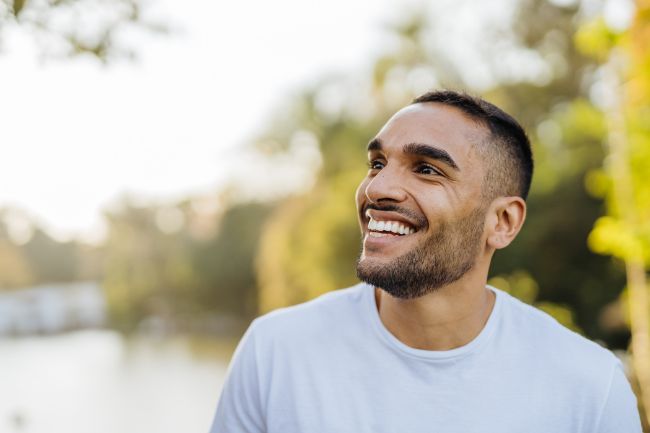 Man in public smiling