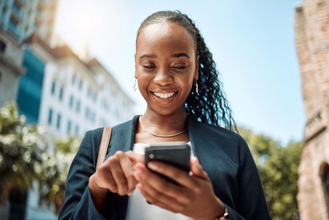 Woman smiling looking down at cellphone