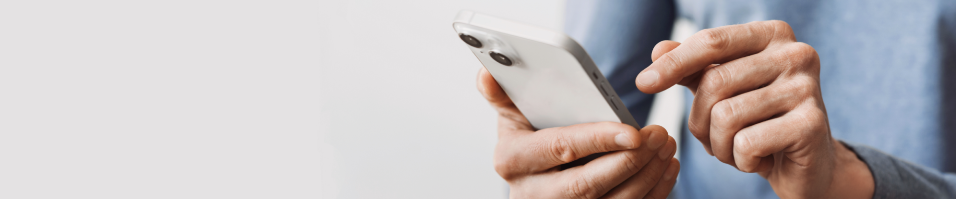 Young man using a smartphone, representing mobile banking and digital convenience.