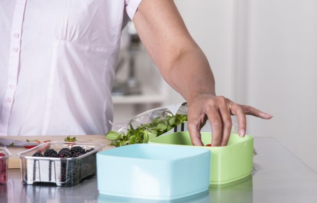 Person preparing a meal in the kitchen, symbolizing home life, care, and everyday moments.